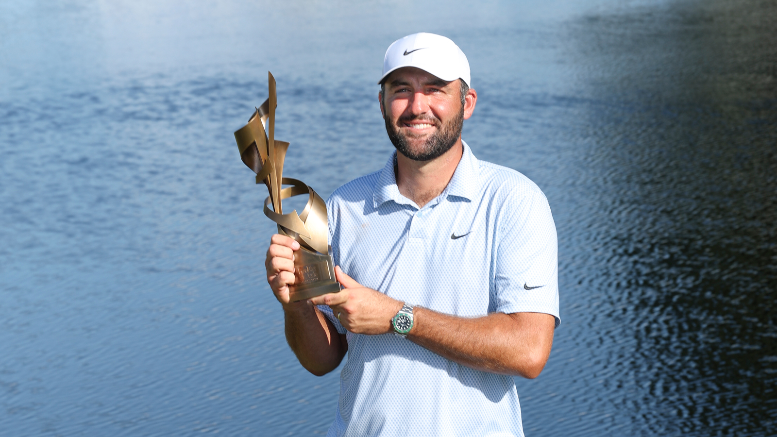Scottie Scheffler holds the FedEx St. Jude Championship trophy