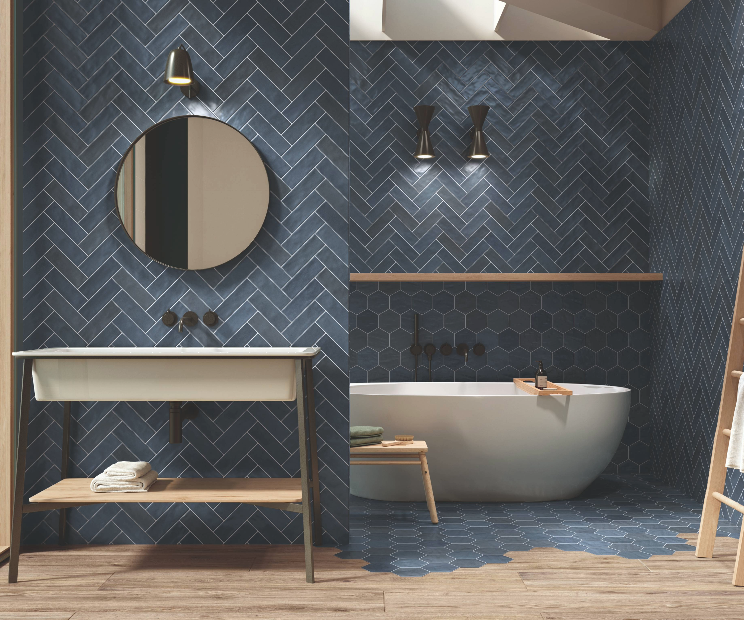 Blue bathroom idea where a freestanding bathtub sits behind a partial wall with a sink