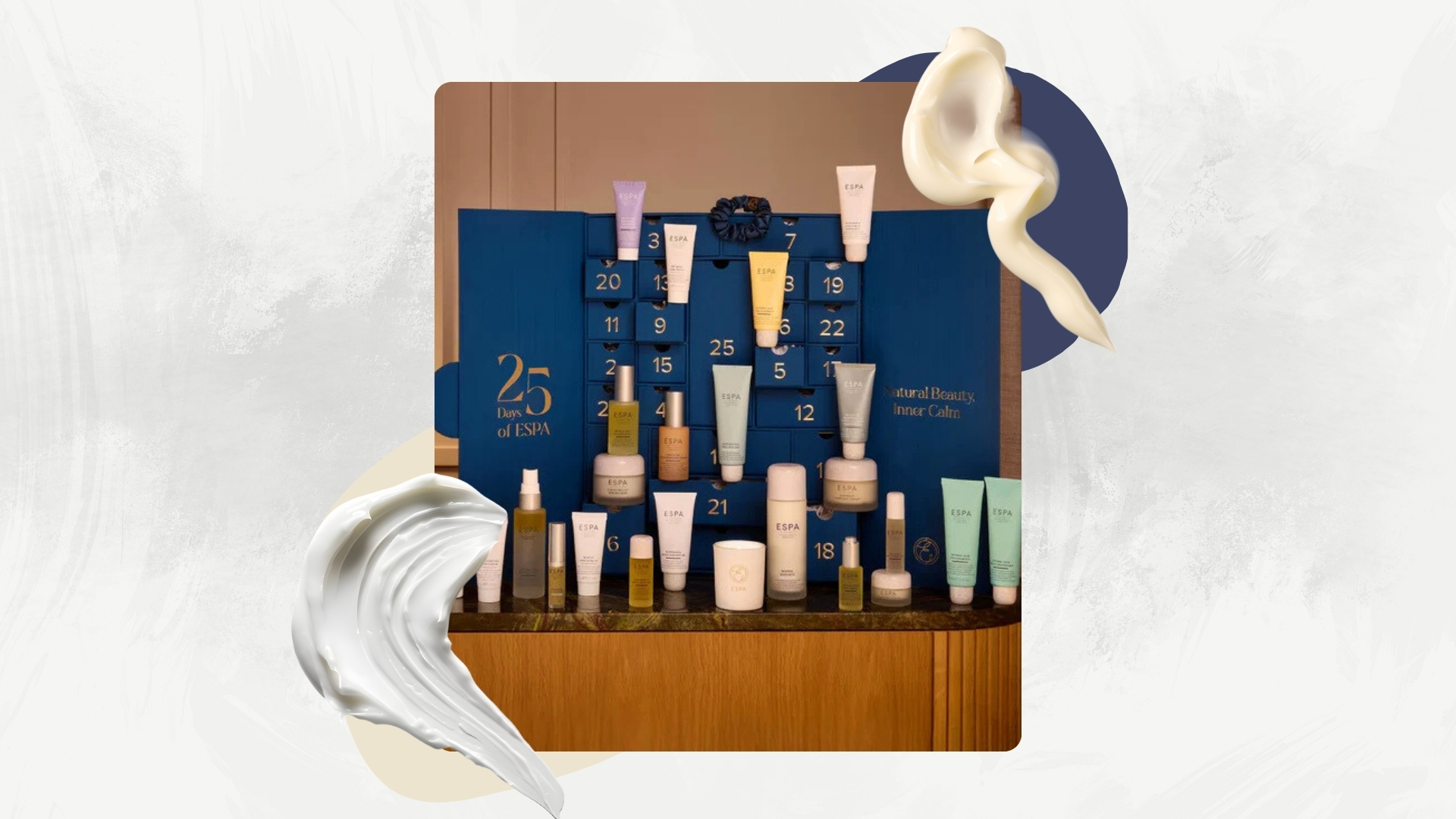 ESPA Wellness Advent Calendar on a white marble background with cream swatches