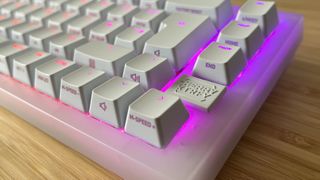 close up on logo pin and keycap build of Cherry XTRFY K5V2 gaming keyboard