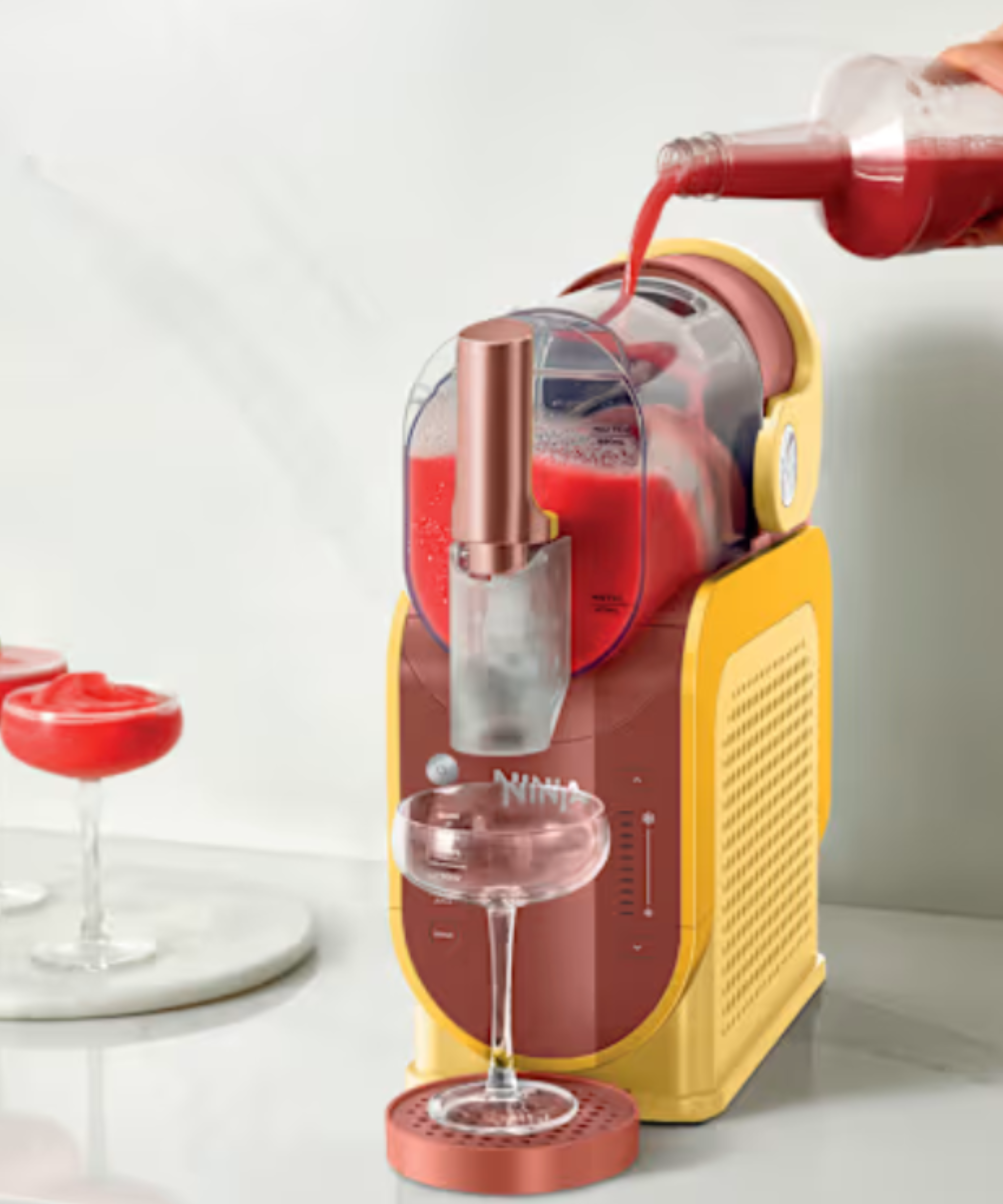 Ninja Slushi&amp;trade; Professional Frozen Drink Maker in the Orange Mango color, making frozen cocktails