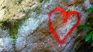 Red heart spray painted on rock