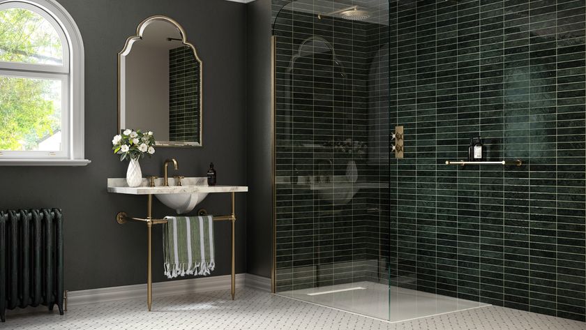 Wet room with green tiles, grey walls and white flooring