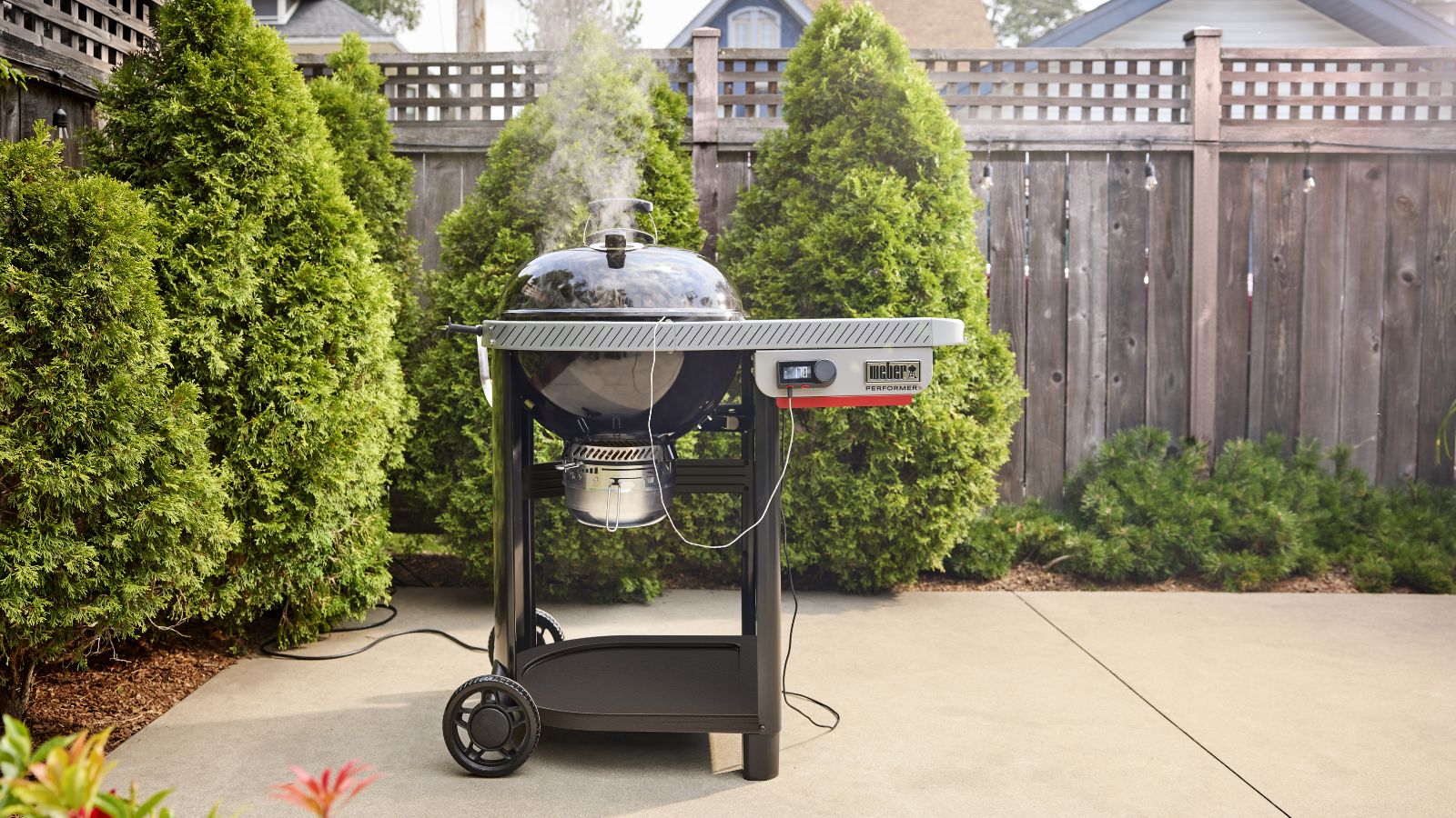Weber Performer Smart Charcoal Grill in backyard