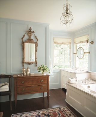 bathroom with large mirror and pale blue walls