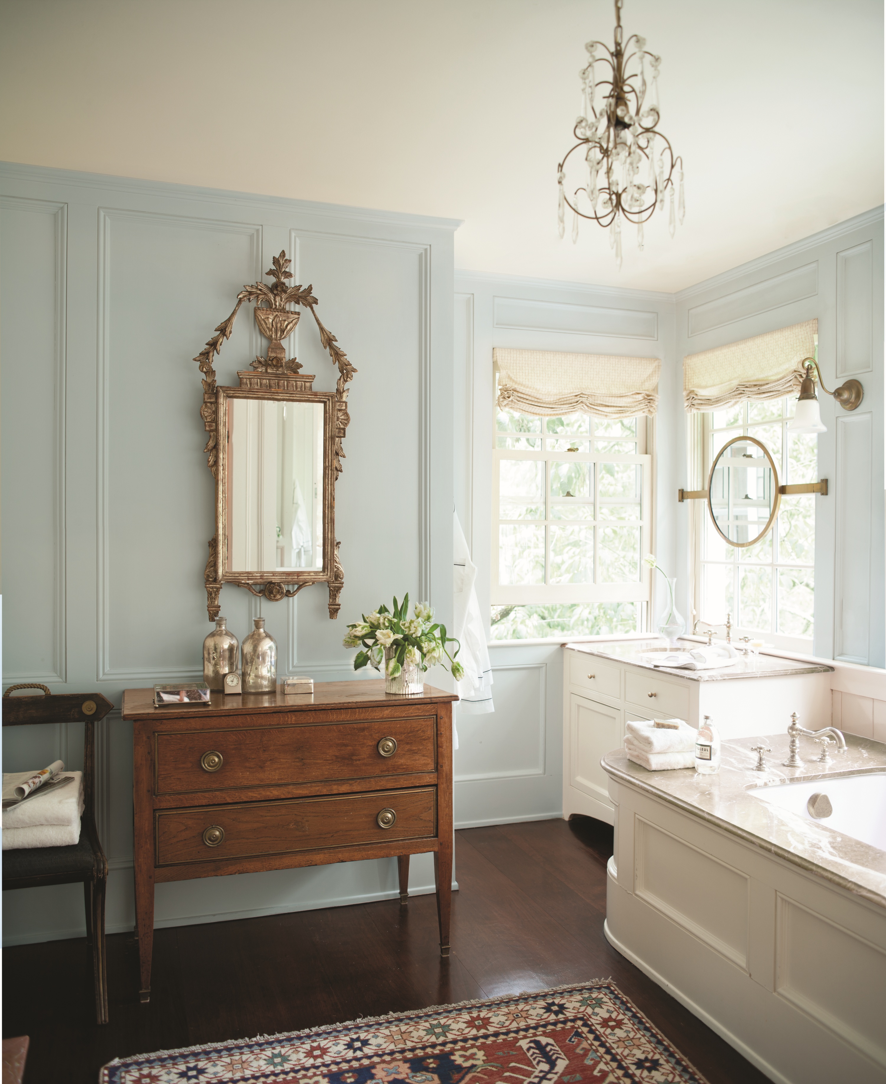 bathroom with large mirror and pale blue walls