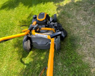 petrol mower cutting a lawn