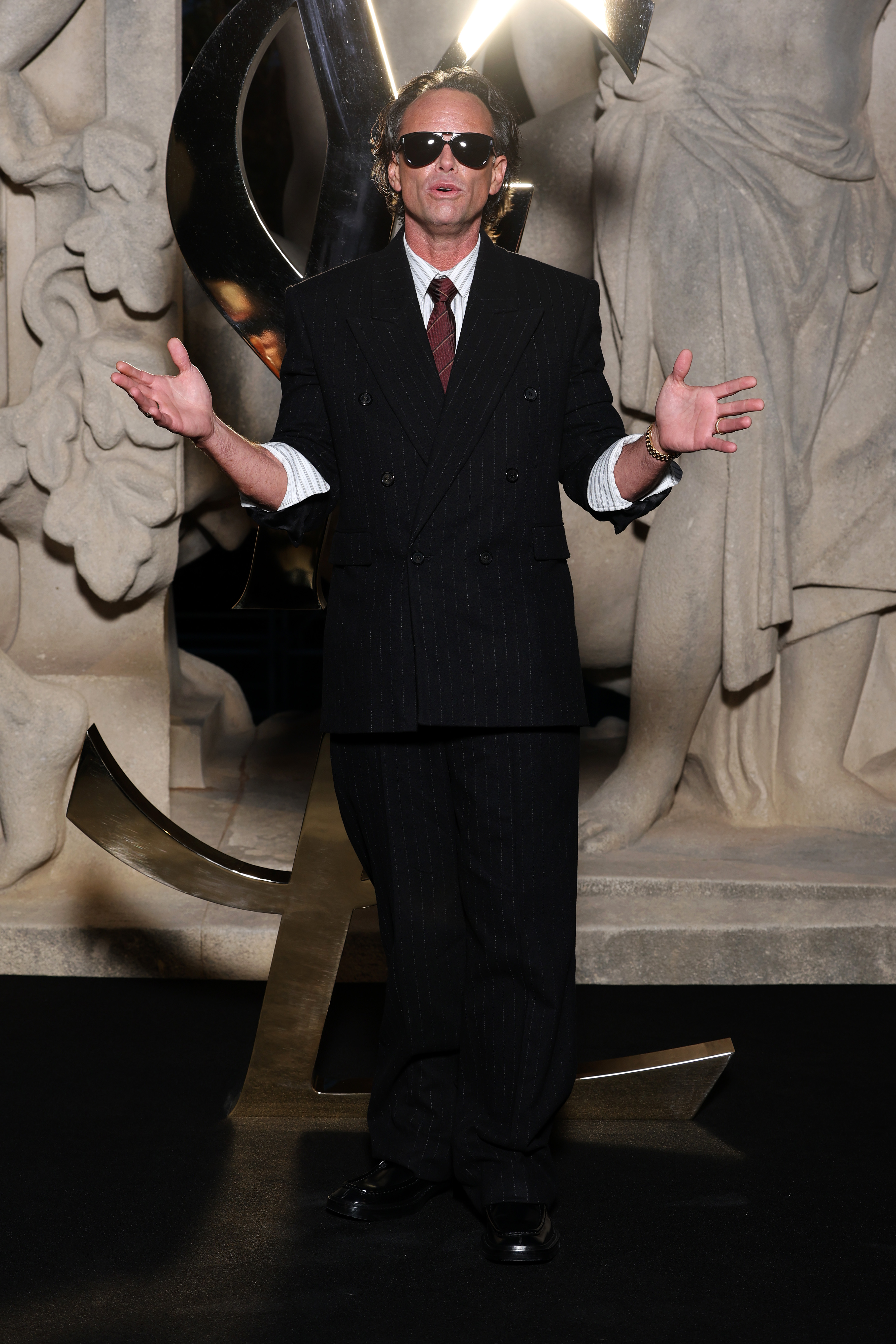 walter goggins wearing a black suit at the saint laurent show