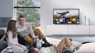 a family in a living room watching Samsung the frame TV 