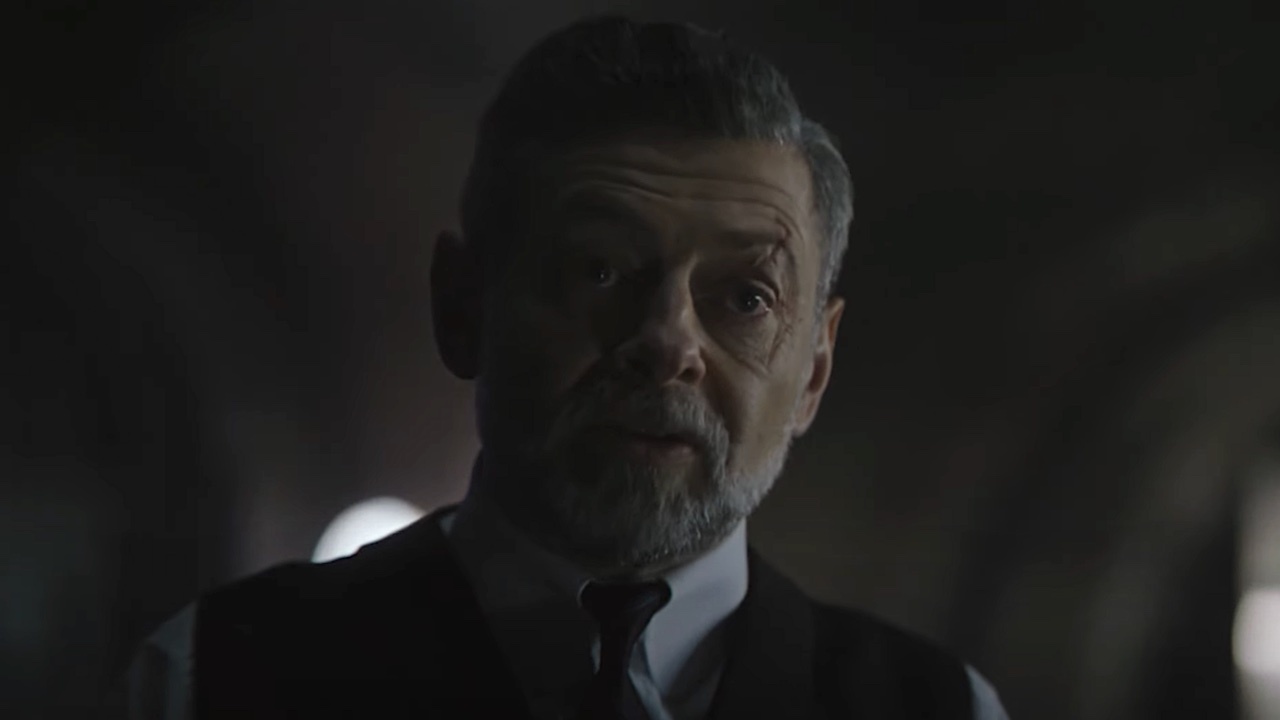Alfred Pennyworth, as portrayed by Andy Serkis in "The Batman," is distinguished by his salt-and-pepper beard and his impeccably dressed suit and tie.