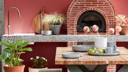roost episode 4 - a terracotta red outdoor kitchen with bench seating and pizza oven - Pic-credit-Little-Greene.-LG-2020---Exterior-Paints-09