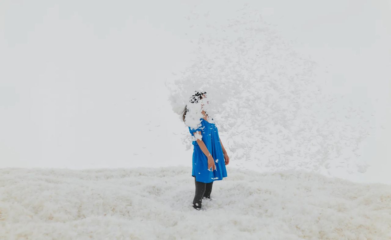 woman amid cloud of feathers: Judy Chicago artwork from one of the art exhibitions to see in January 2024