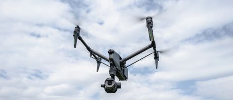 DJI Inspire 3 drone in flight against a intermittent cloudy sky