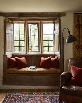 window seat in front of traditional window in cotswold home