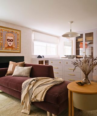 room with brown chaise and drawers