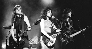 A B/W live shot of the Bangles performing for a music video [l-r]: Vicki Peterson, Susanna Hoffs and Michael Steele