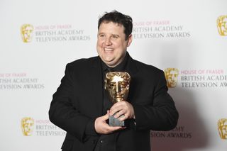 Peter Kay holding a BAFTA