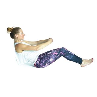 A young woman in exercise clothes lying on her back with her hands flat on the floor, one leg bent with foot on the floor, the other raised straight to the ceiling, doing a leg circle