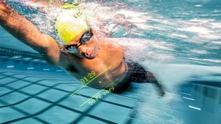 Man swimming while wearing Form goggles and using HeadCoach app