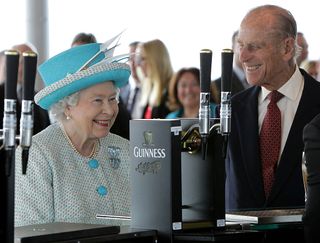 Britain's Queen Elizabeth II (L) and Prince Philip,The Duke of Edinburgh visit the Guinness Storehouse Gravity Bar in Dublin, on the second day of the Queen's four-day visit to Ireland, on May 18, 2011. Queen Elizabeth II Wednesday visits an Irish stadium where British troops massacred 14 people, trying to heal old wounds in a historic step that would have been unthinkable for most of her reign.