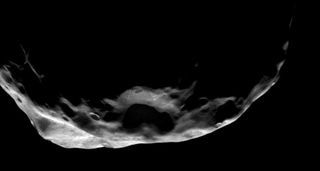This shadowy scene is one of the Cassini spacecraft's closest views of Saturn's moon Janus. The moon is 111 miles (179 km) across and was photographed by Cassini on June 30, 2008.