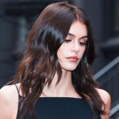 Kaia Gerber pulls off knee-high boots and a mini-skirt in summer.