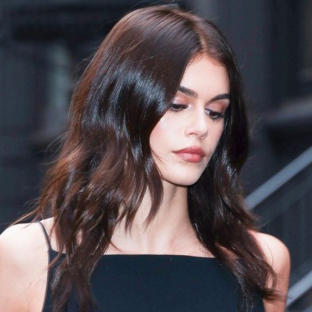 Kaia Gerber pulls off knee-high boots and a mini-skirt in summer.
