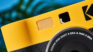 A black and yellow Kodak Mini Shot 3 Era 2-in-1 instant camera and printer