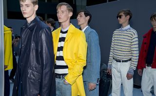 Male models wearing dark and bright jackets and striped tops from the Dior SS2015 collection