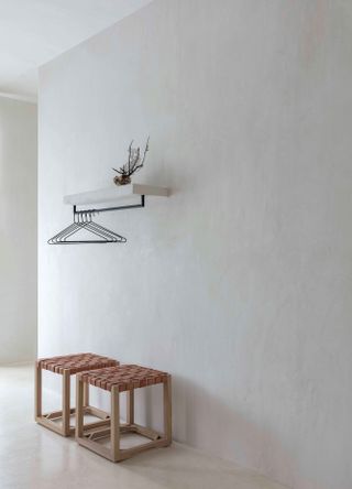 Stools and clothes hangers in bedroom