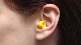 Close up of an earplug in a woman's ear
