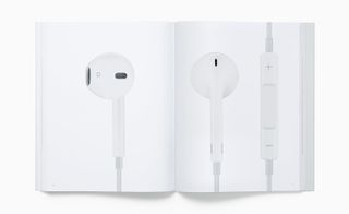 View of two pages inside the 'Designed by Apple in California' book featuring photos of the 2012 Apple EarPods