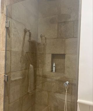 Shower with brown large tiles