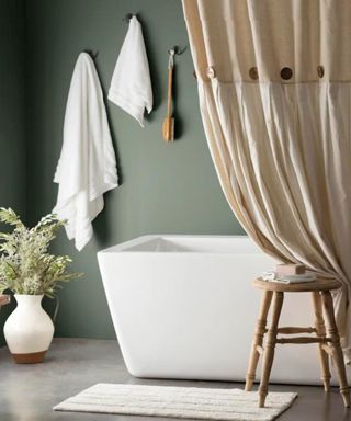 Organic beige shower curtain in a green bathroom