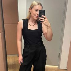Florrie wears the black tailored trousers from COS