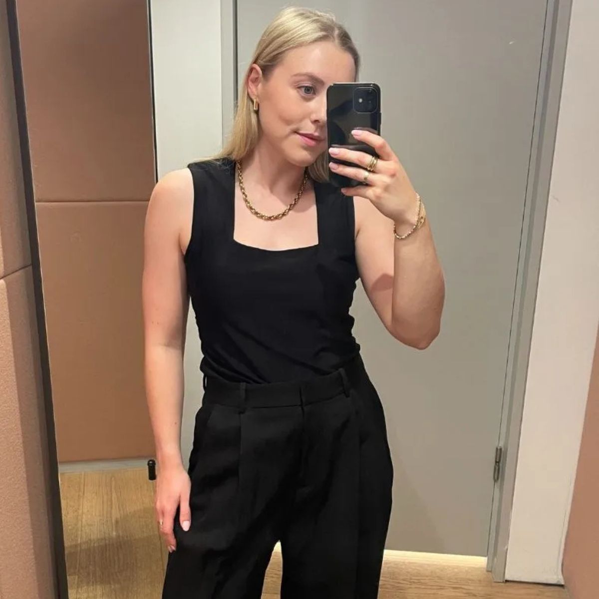 Florrie wears the black tailored trousers from COS