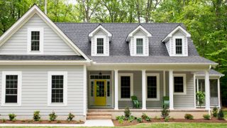 large home exterior with shiplap and landscaping