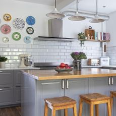 kitchen room with white tiled walls and kitchen chimney