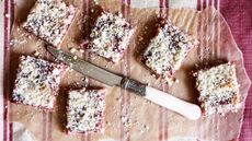Plum flapjacks cut into squares and placed on a piece of brown baking paper
