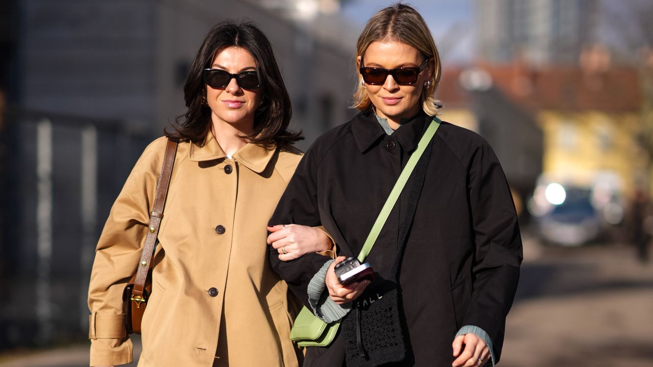 Two women at Copenhagen Fashion Week wearing neutral trench coats in a guide to the best Nordstrom Winter Sale deals