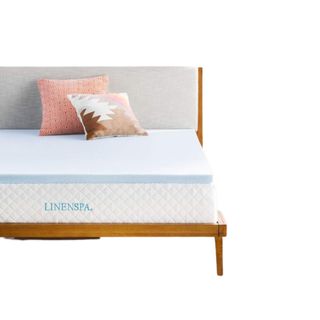 A blue mattress topper on a bed
