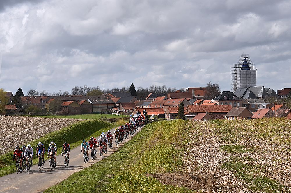 The peloton races through the cobbles, fields at Gent-Wevelgem