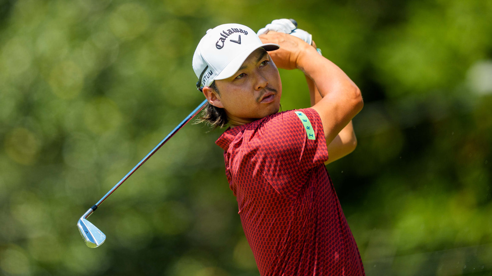 Min Woo Lee hits an iron shot
