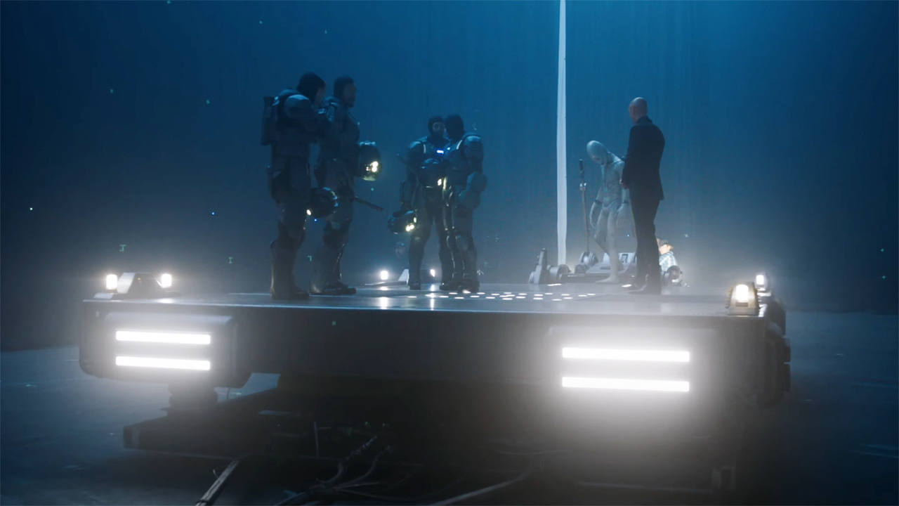 Soldiers, Mr Handsome, and Lex Luthor standing on a platform in 2025's Superman movie