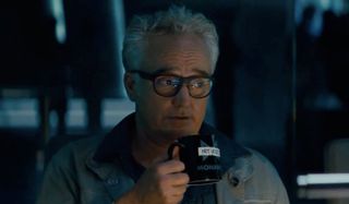 Godzilla: King of the Monsters Dr. Stanton sipping his coffee while saying something snarky