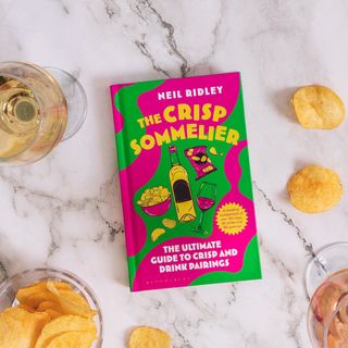 The Crisp Sommelier book on table with wine and crisps