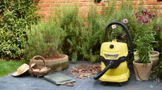 A yellow garden vacuum cleaner on a patio
