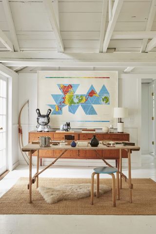 white summer house with bold artwork used as a home office