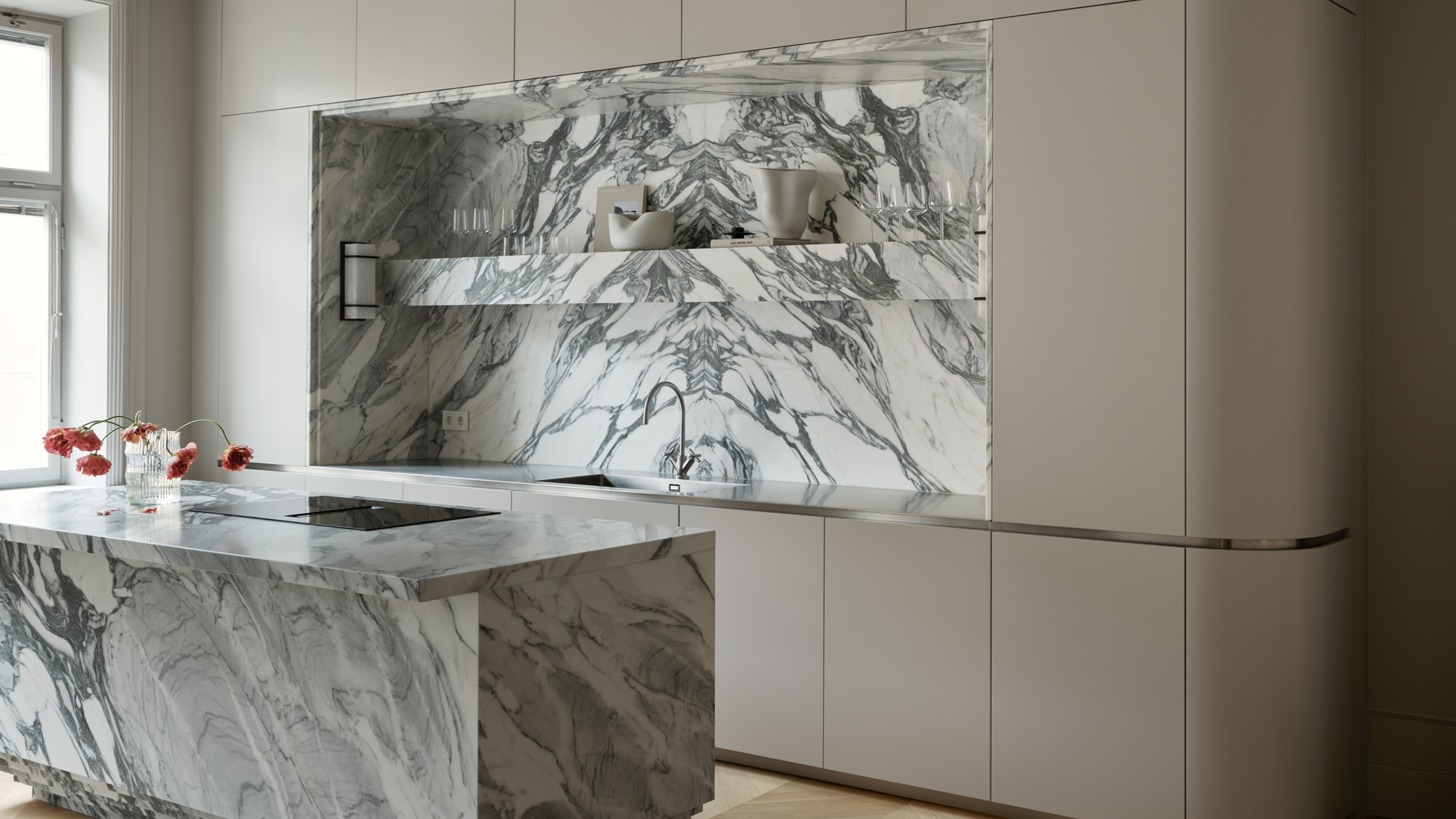 sleek modern kitchen with marble island and backsplash