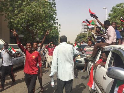 Protesters flash victory signs in Sudan